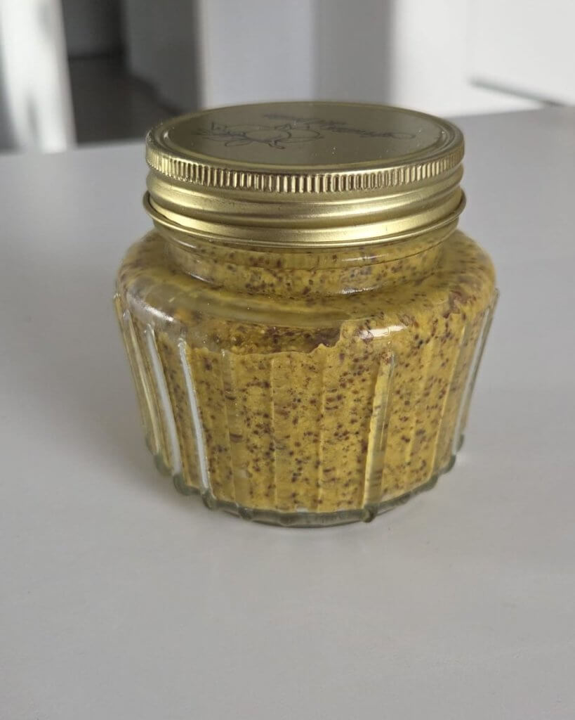 Pot zelfgemaakte mosterd met gouden deksel